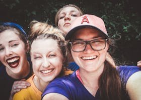 A joyful group of women taking a selfie outdoors, showcasing happiness and friendship.
